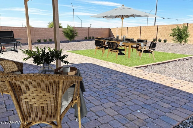 view of patio / terrace featuring area for grilling and a fenced backyard