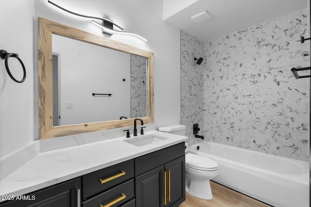 bathroom with  shower combination, vanity, toilet, and wood finished floors