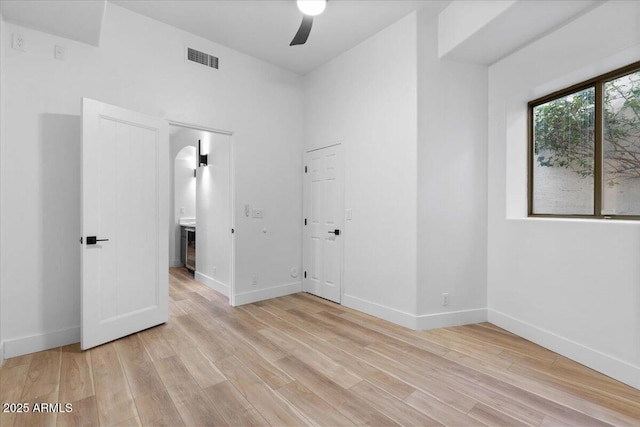 spare room featuring light wood-style floors and baseboards