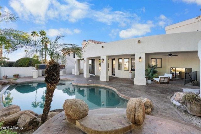 view of pool with fence, a ceiling fan, and a patio