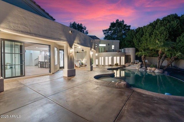 outdoor pool with a patio area