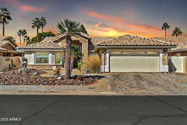 mediterranean / spanish-style home featuring a garage