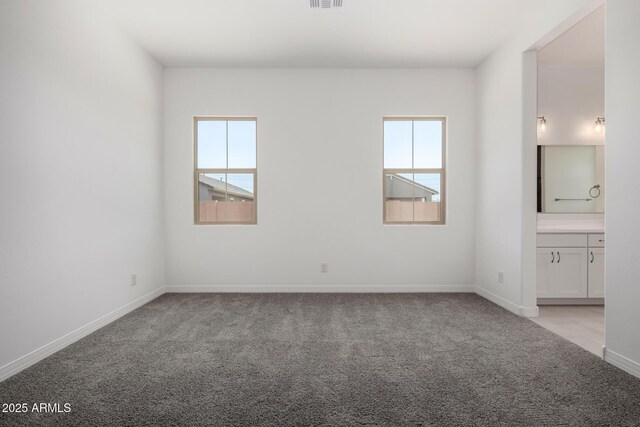 12029 W Marguerite Ave, Avondale, AZ 85323 - spare room featuring healthy amount of natural light, light colored carpet, and baseboards