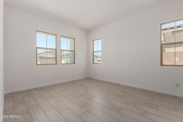 12029 W Marguerite Ave, Avondale, AZ 85323 - spare room with healthy amount of natural light, baseboards, and light wood-style flooring