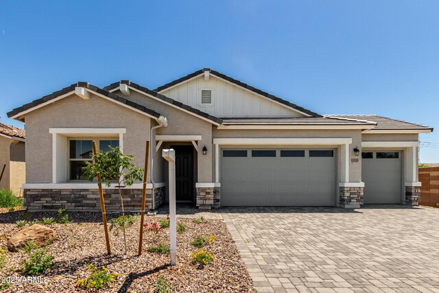 12029 W Marguerite Ave, Avondale, AZ 85323 - view of front of property with stone siding, a garage, decorative driveway, and a tiled roof