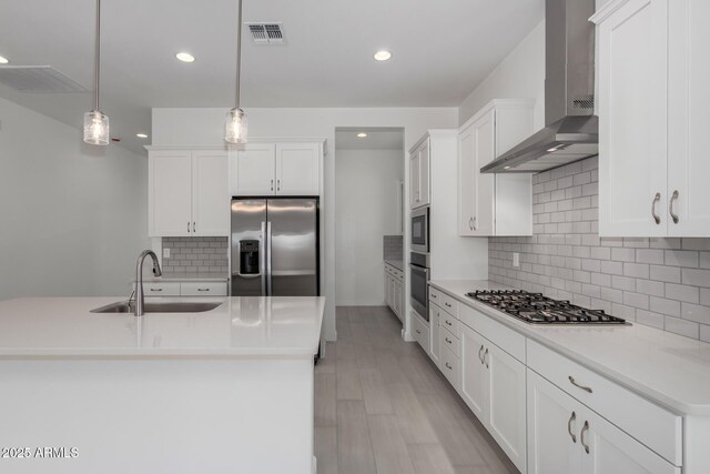 12029 W Marguerite Ave, Avondale, AZ 85323 - kitchen with a sink, stainless steel appliances, wall chimney exhaust hood, white cabinetry, and recessed lighting