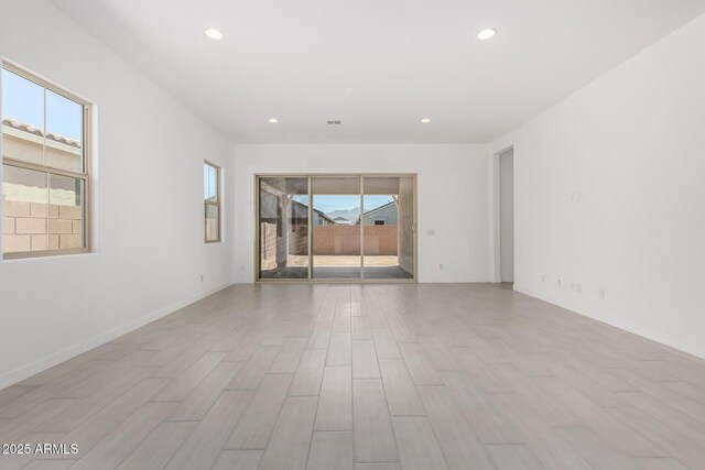 12029 W Marguerite Ave, Avondale, AZ 85323 - empty room with healthy amount of natural light, recessed lighting, light wood finished floors, and baseboards