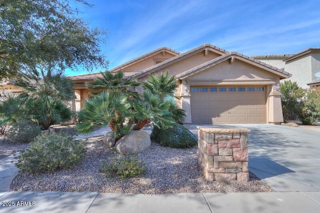 view of front of property featuring a garage, concrete driveway, and stucco siding