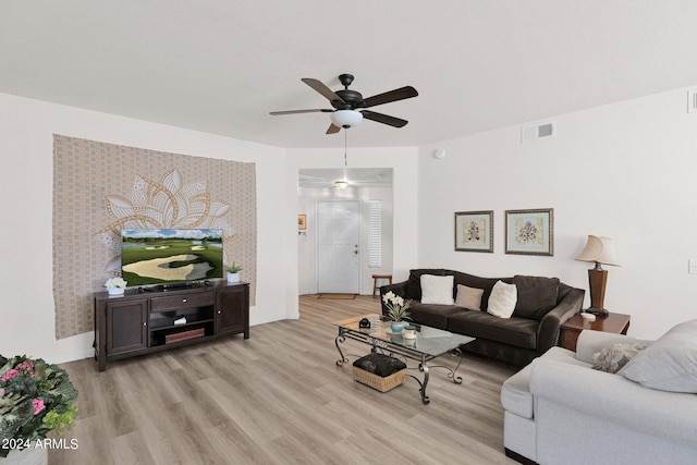 living room featuring ceiling fan and light hardwood / wood-style floors