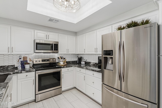 7575 E Indian Bend Rd Unit 1142, Scottsdale, AZ 85250 - kitchen featuring stainless steel appliances, white cabinetry, backsplash, and light tile patterned floors