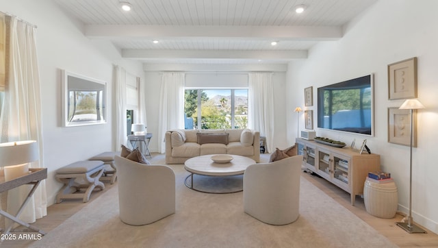 living room with beamed ceiling and light hardwood / wood-style flooring