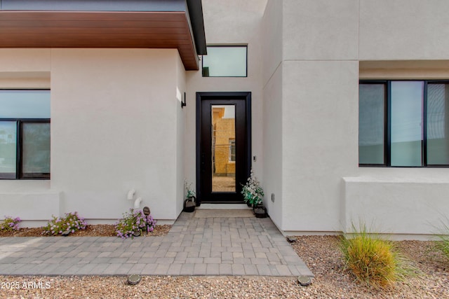 doorway to property with stucco siding