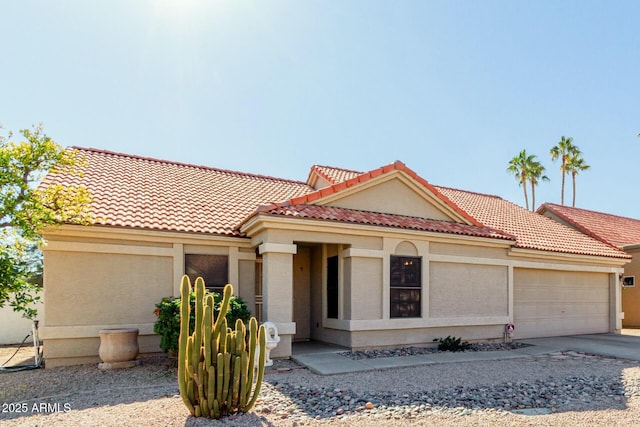 mediterranean / spanish home with a garage