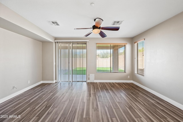 spare room featuring a ceiling fan, visible vents, and baseboards