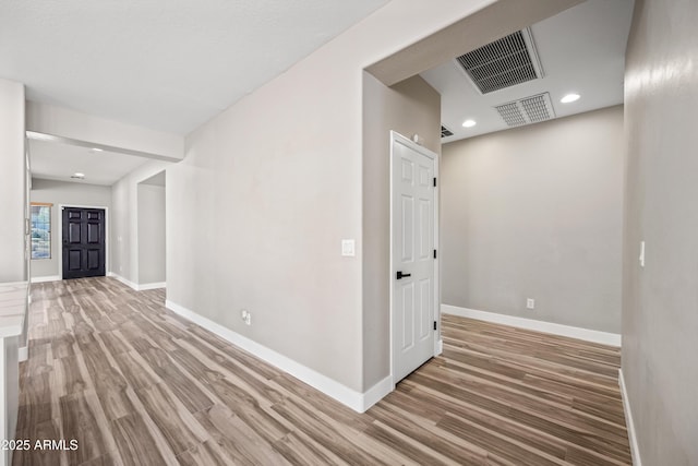 interior space featuring wood finished floors, recessed lighting, visible vents, and baseboards