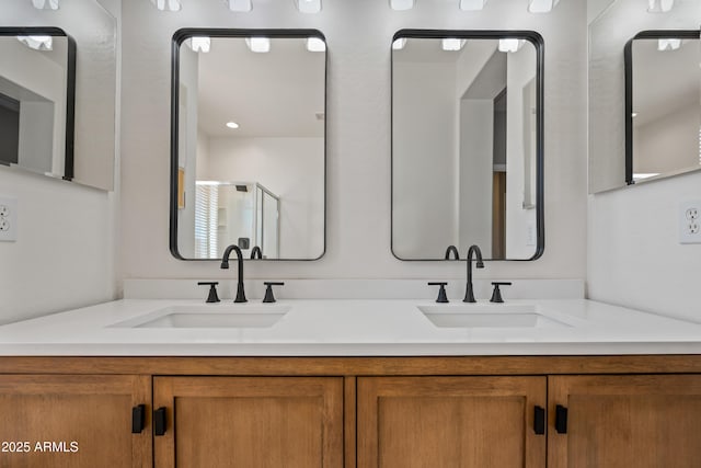 full bathroom with double vanity and a sink