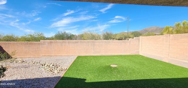 view of yard with a mountain view and a fenced backyard