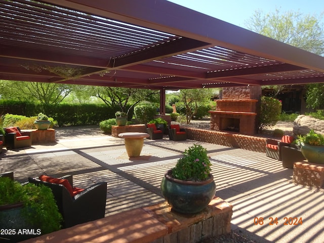 view of patio / terrace with a pergola and exterior fireplace