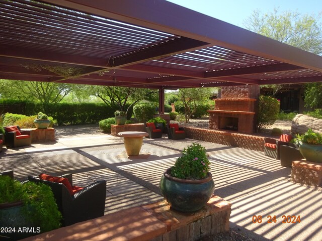 view of patio with a pergola and exterior fireplace