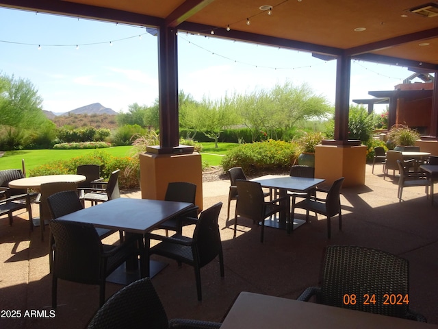 view of patio / terrace with a mountain view, outdoor dining area, and visible vents