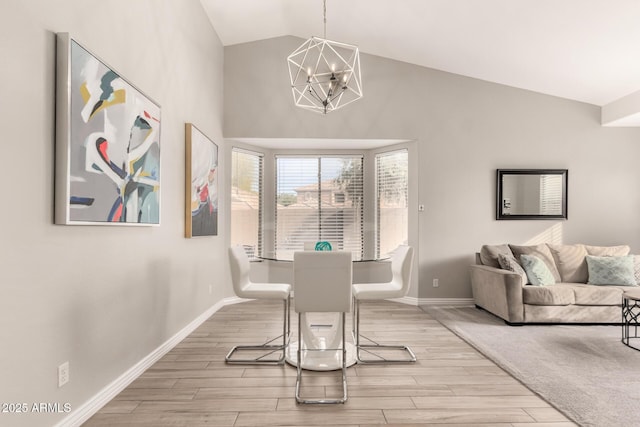 dining space featuring vaulted ceiling and a chandelier