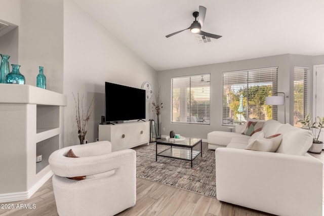 living room featuring ceiling fan, light hardwood / wood-style flooring, and lofted ceiling