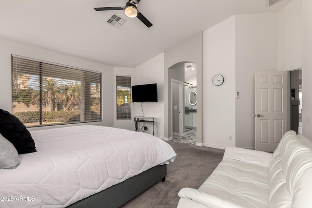 bedroom featuring ceiling fan, carpet, lofted ceiling, and connected bathroom