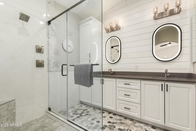 bathroom featuring vanity, wood walls, and walk in shower