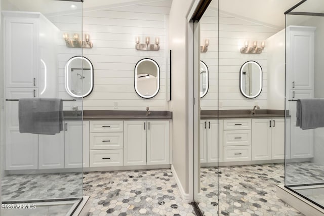 bathroom with an enclosed shower, vaulted ceiling, and vanity