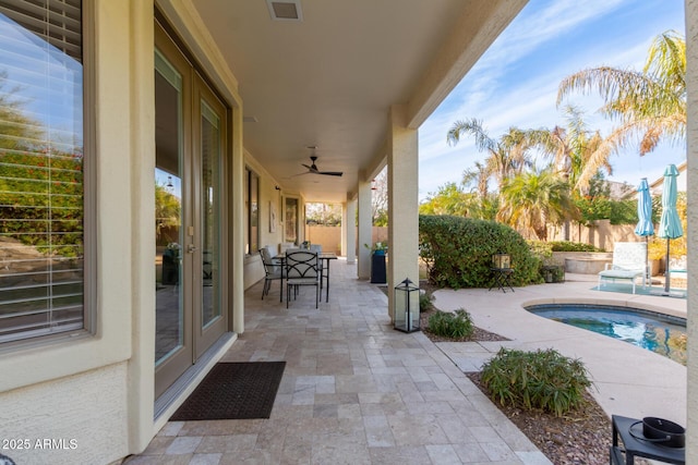 view of patio with ceiling fan, french doors, and a fenced in pool