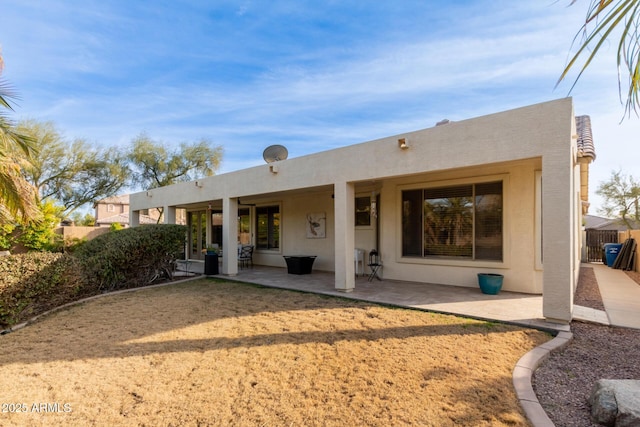 rear view of property featuring a patio