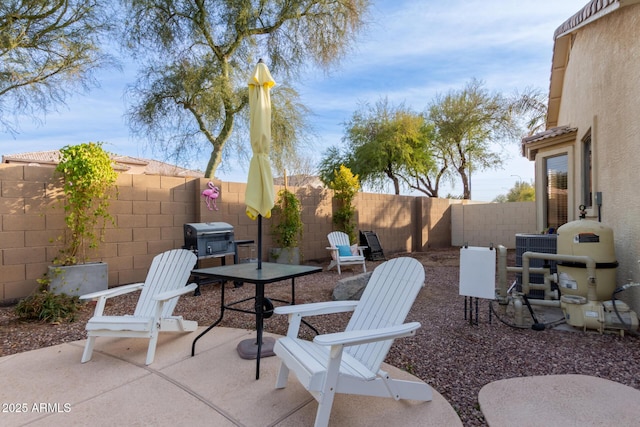 view of patio featuring central air condition unit and a grill