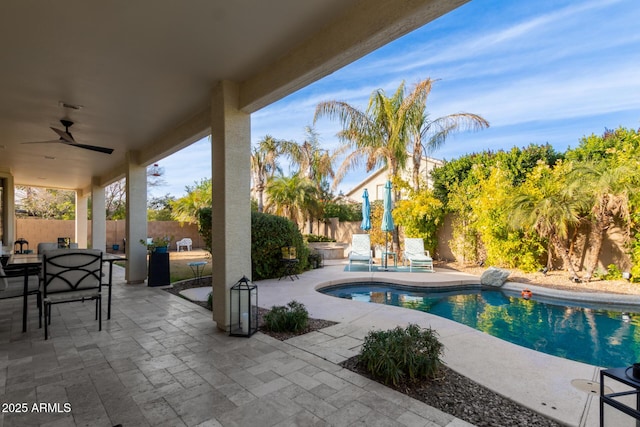 view of swimming pool featuring ceiling fan and a patio