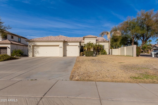 mediterranean / spanish-style home with a front yard and a garage