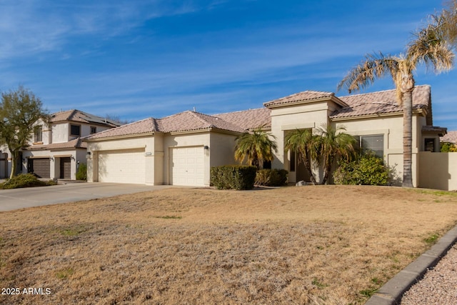 mediterranean / spanish-style home featuring a garage and a front lawn