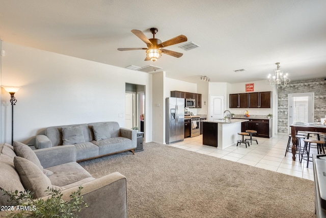 4080 N 309th Cir, Buckeye, AZ 85396 - living room featuring a ceiling fan, light tile patterned floors, a chandelier, and light colored carpet