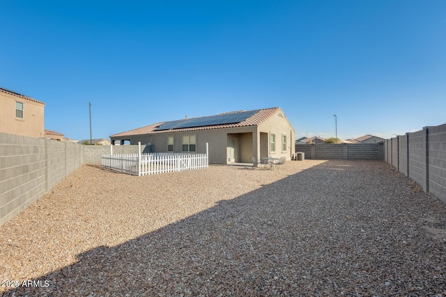 4080 N 309th Cir, Buckeye, AZ 85396 - back of house featuring solar panels, stucco siding, a fenced backyard, and a tile roof