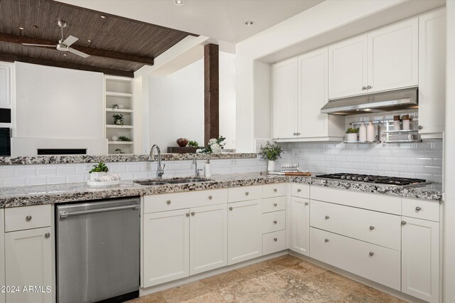 kitchen with appliances with stainless steel finishes, wood ceiling, a sink, light stone countertops, and under cabinet range hood