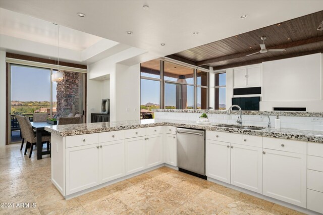 kitchen featuring stainless steel dishwasher, plenty of natural light, wood ceiling, backsplash, and white cabinetry