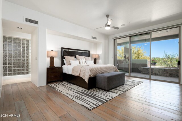 bedroom with access to exterior, ceiling fan, and hardwood / wood-style floors