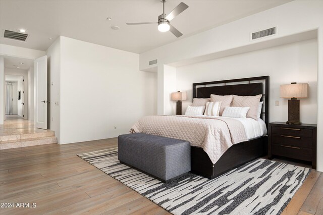 bedroom with ceiling fan and light hardwood / wood-style floors