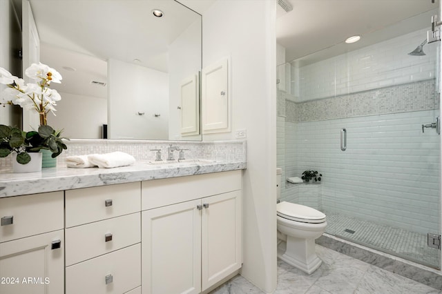 bathroom with a stall shower, decorative backsplash, toilet, marble finish floor, and vanity