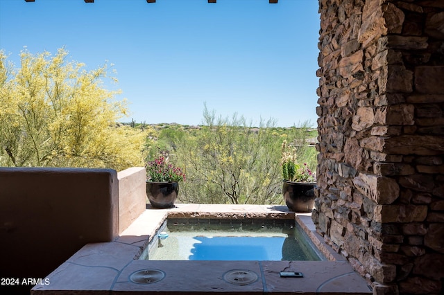 view of swimming pool featuring an in ground hot tub