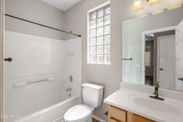full bathroom with vanity, washtub / shower combination, baseboards, and toilet