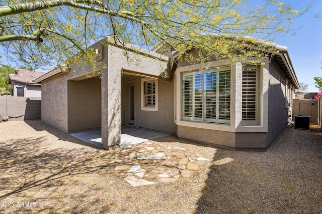 back of house with a patio, cooling unit, stucco siding, and fence