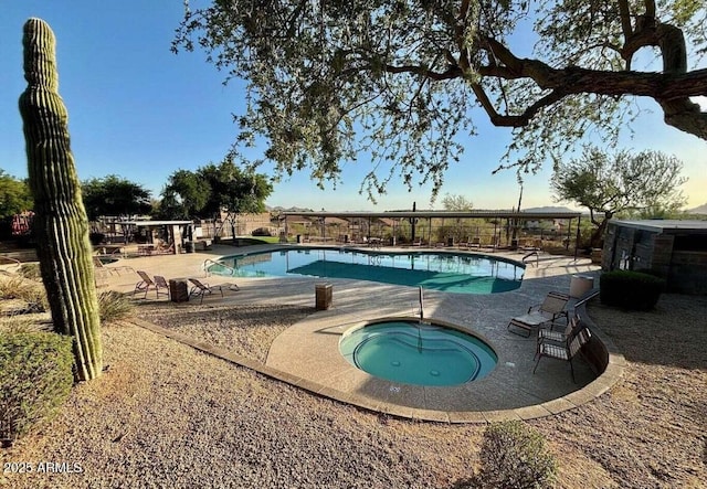 pool with a patio and a community hot tub