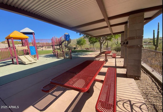 view of home's community with fence and playground community