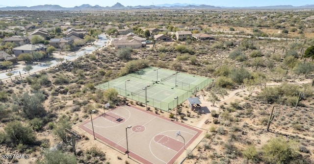 drone / aerial view featuring a mountain view and a desert view