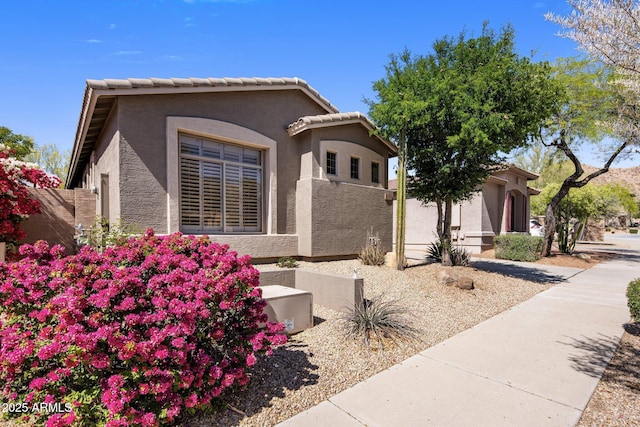 view of front of property with stucco siding and a tiled roof