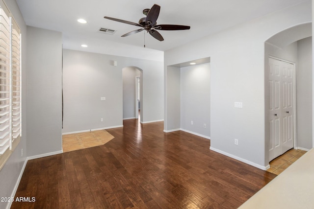 spare room with ceiling fan, visible vents, arched walkways, wood finished floors, and recessed lighting